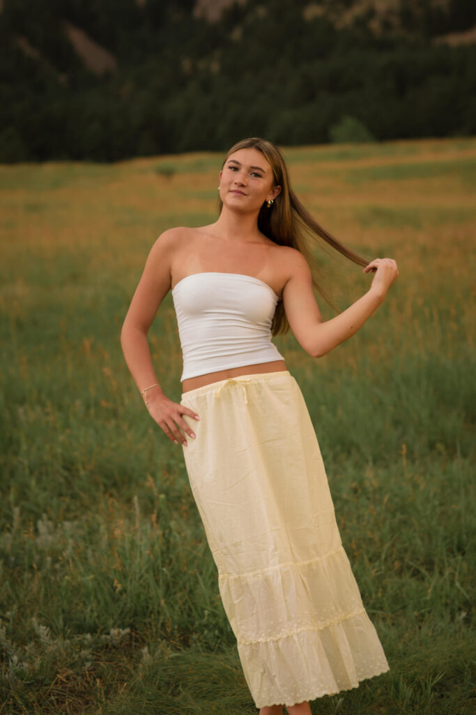 Boulder senior photo at Chautauqua Park with Flatirons mountain backdrop and tall meadow grass
