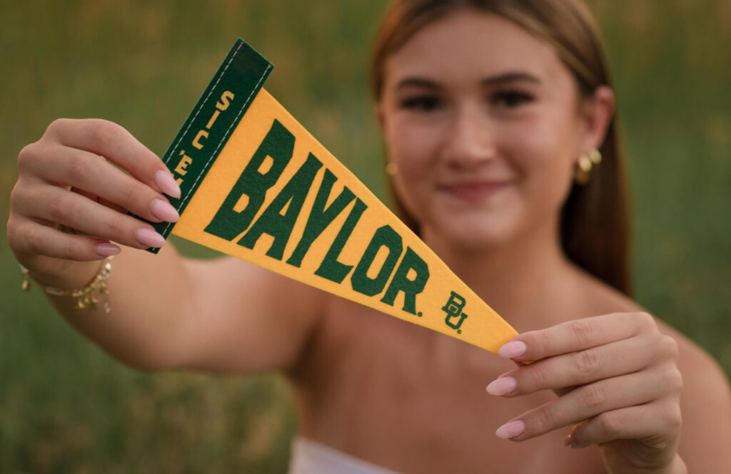 Boulder senior photo at Chautauqua Park with senior holding Baylor University pennant