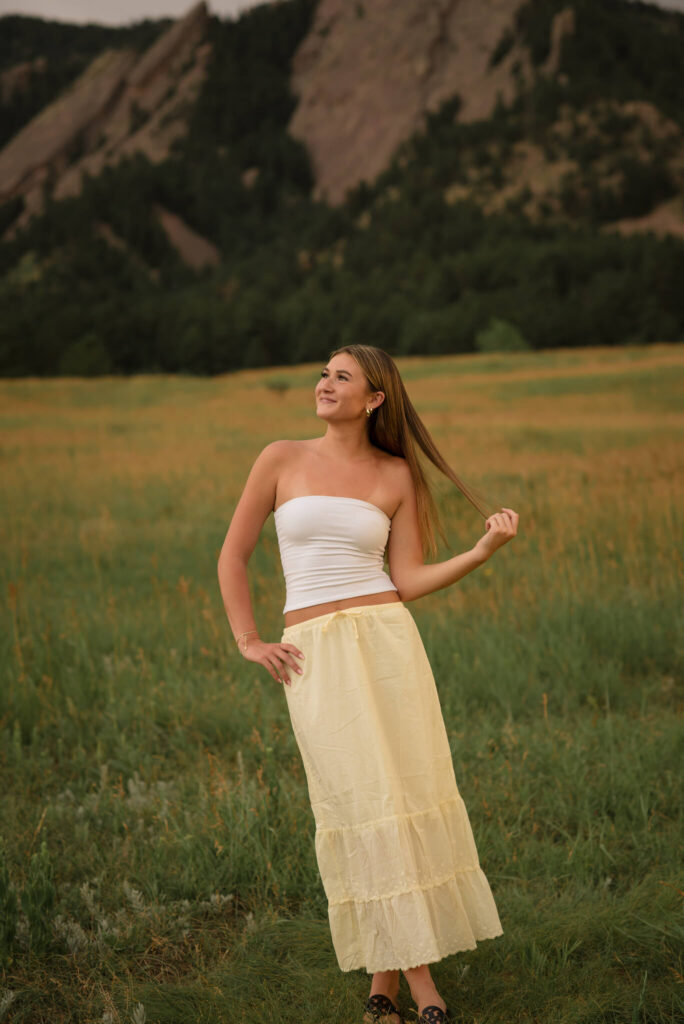 Boulder senior photo at Chautauqua Park with Flatirons mountain backdrop and golden meadow