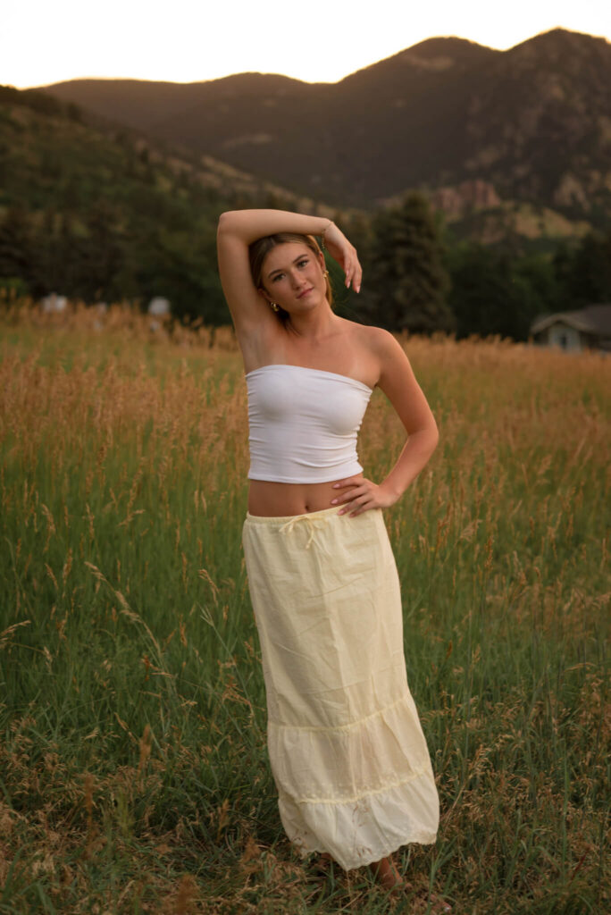 Boulder senior photo at Chautauqua Park with Flatirons mountain backdrop during golden hou