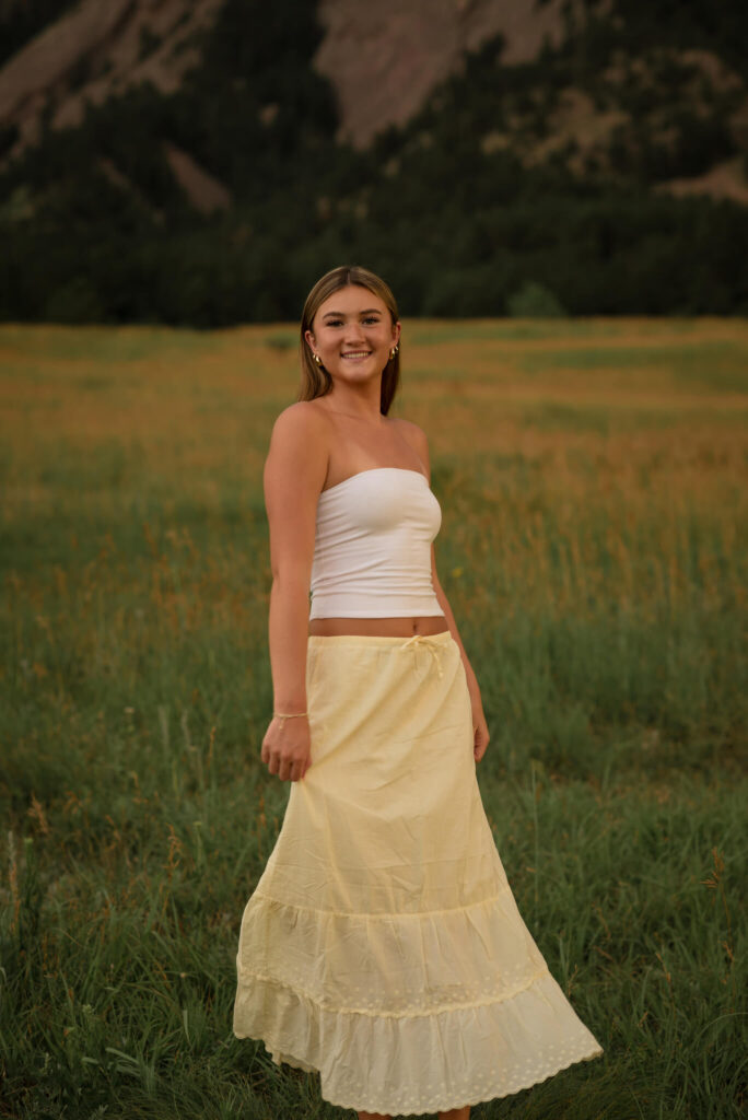 Boulder senior photo at Chautauqua Park with Flatirons mountain backdrop during golden hour