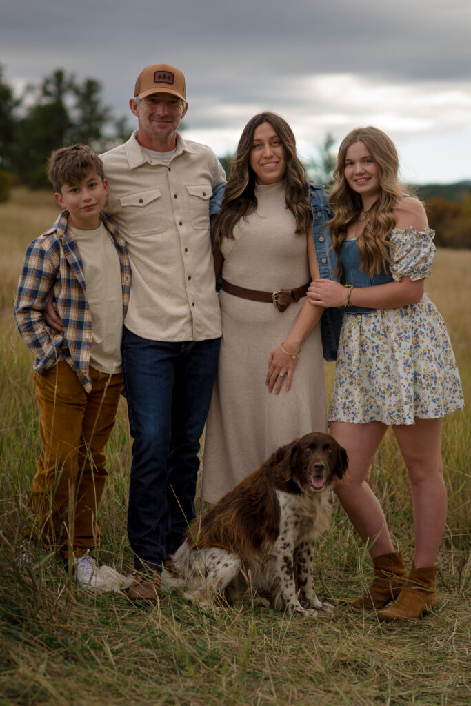 Family portrait with their dog during a dog family photo shoot in Castle Rock, Colorado