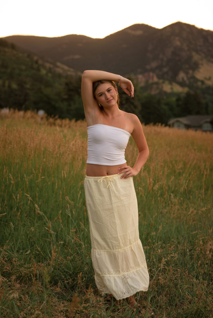 Castle View High School senior photos at Chautauqua Park in Boulder featuring a senior standing in a wildflower meadow with the Flatirons in the background
