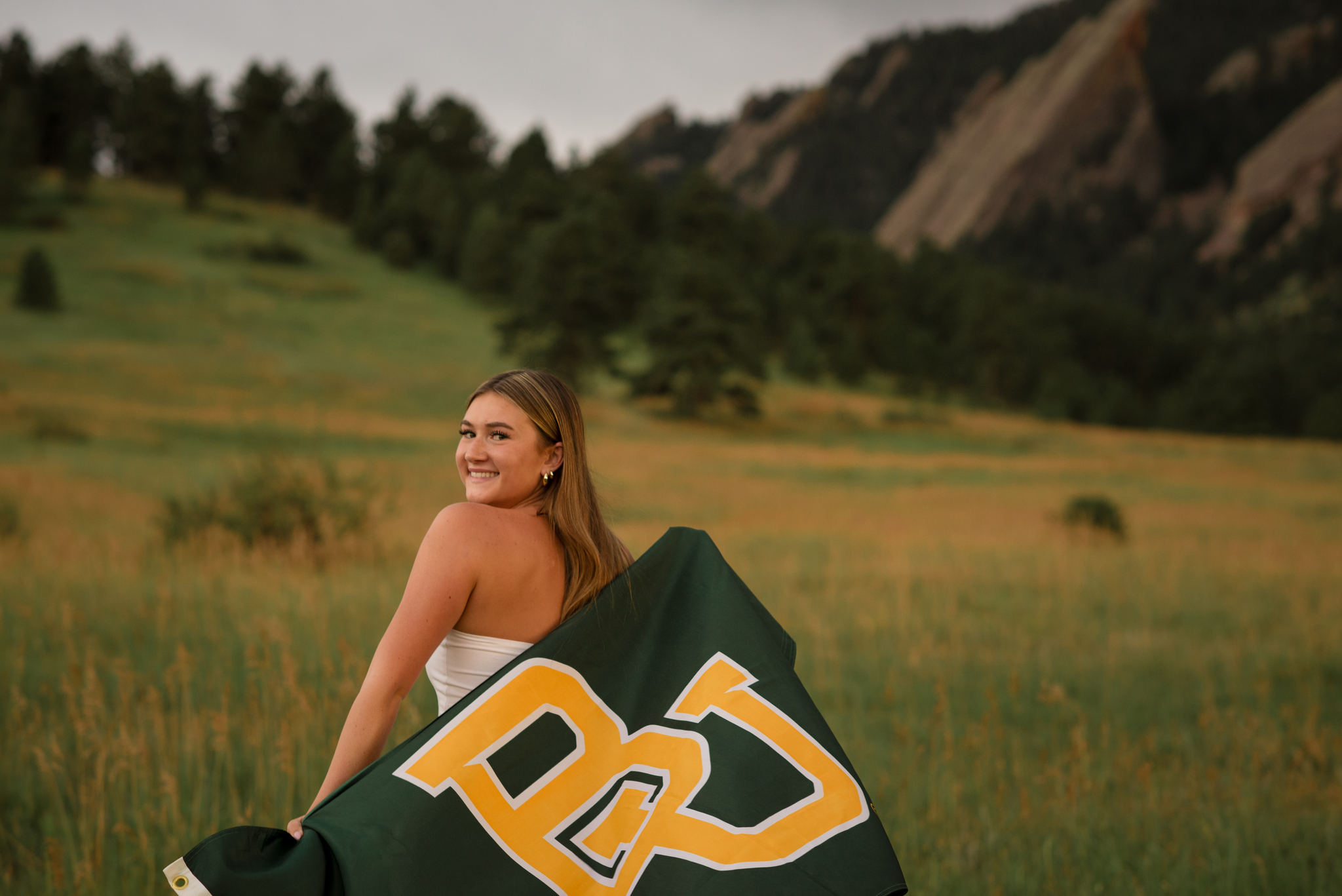 Boulder senior portraits with a Castle View High School senior posing in front of the Flatirons during golden hour.