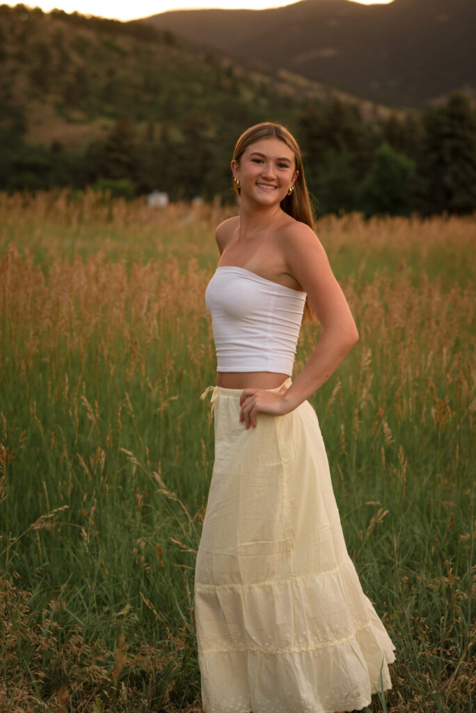 Senior portrait session at Chautauqua Park in Boulder with a Castle View High School senior surrounded by tall grasses and mountain views.