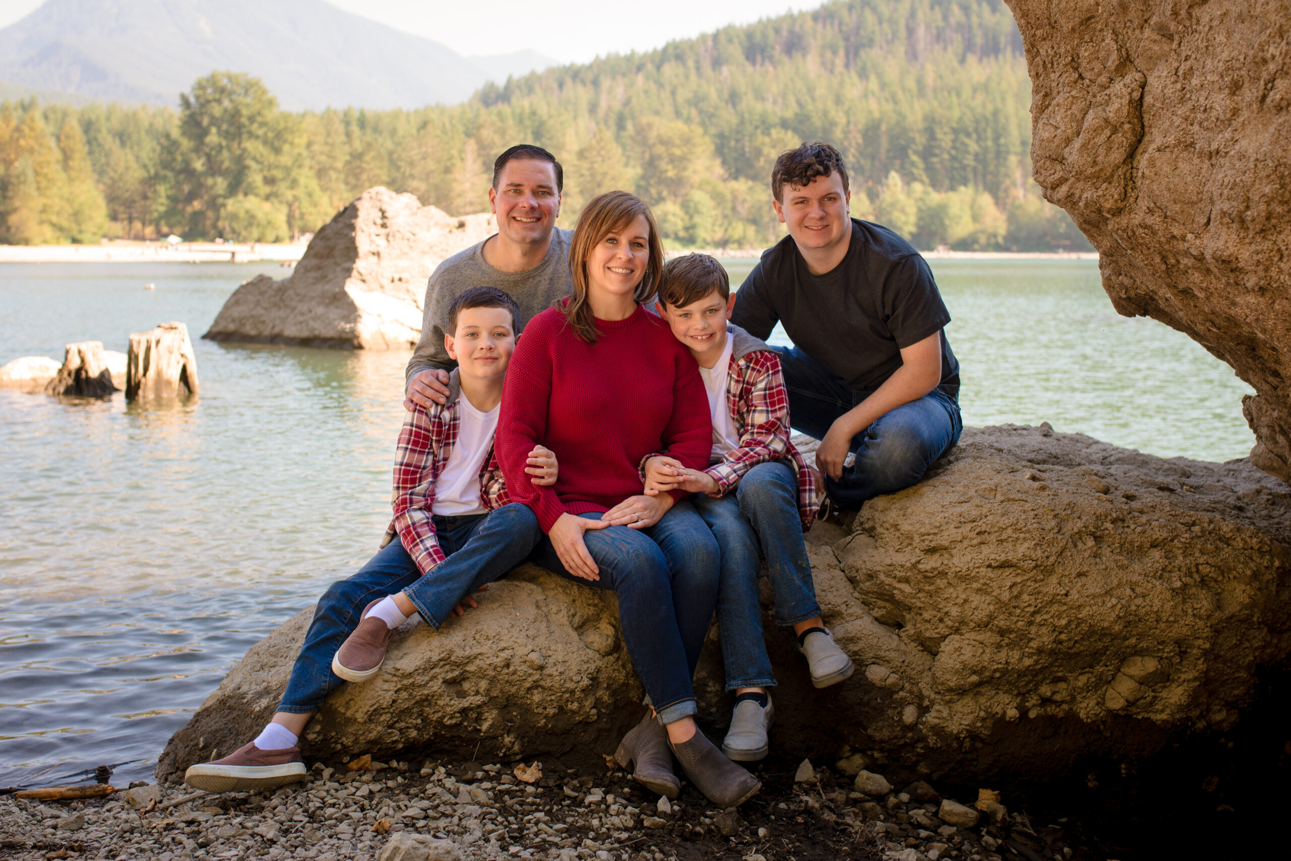 Family sitting on rock at Rattlesnake Lake